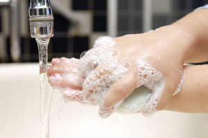 Soapy hands of little child hand-washing in the sink